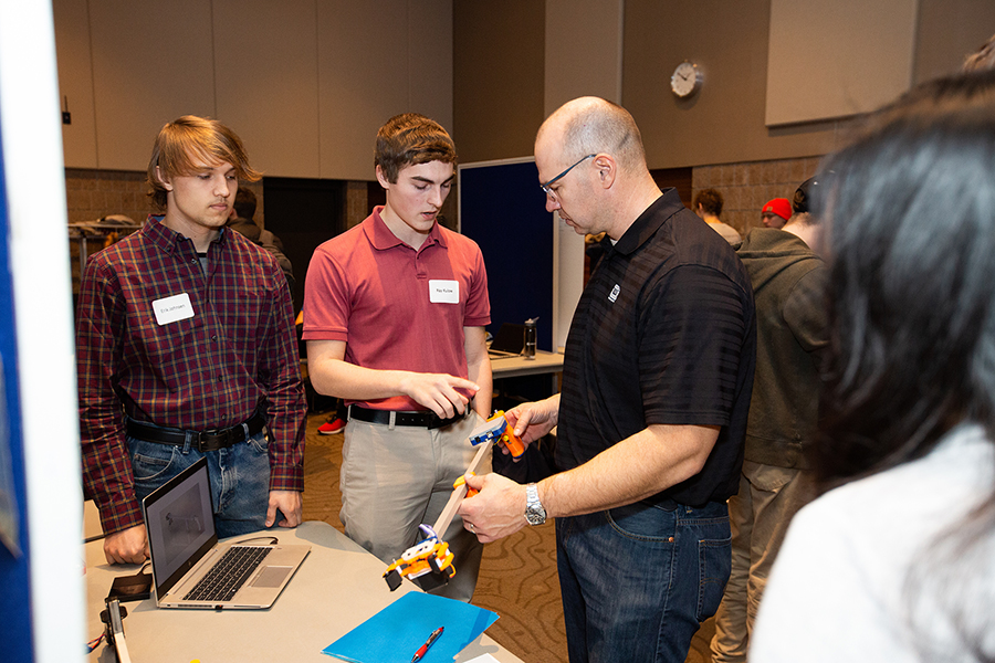 Students Erik Johnson, at left, and Ray Kulow explain their research project the ‘Grabba.’