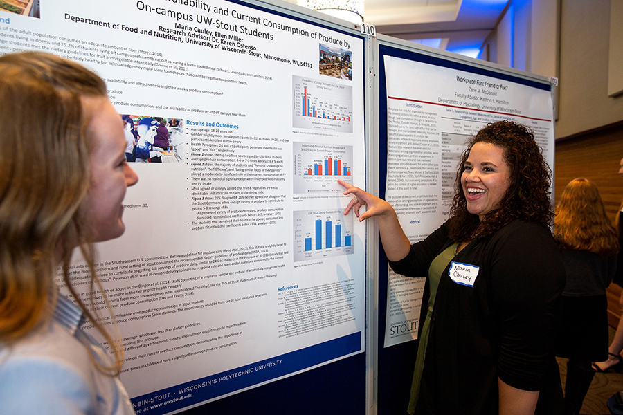 UW-Stout graduate students Maria Cauley, at right, and Ellen Miller discuss their research on college students’ nutrition.