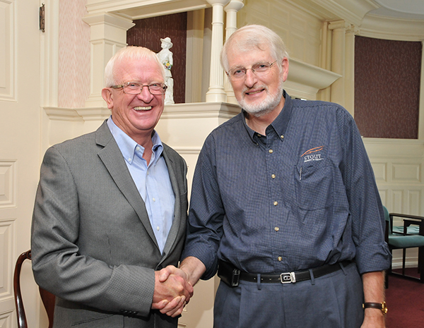 Dave Williams, right, is congratulated at his retirement reception in 2011 by Charles W. Sorensen, then chancellor of UW-Stout.