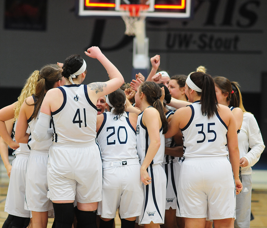 The UW-Stout women’s basketball team huddles prior to a WIAC playoff game in February.
