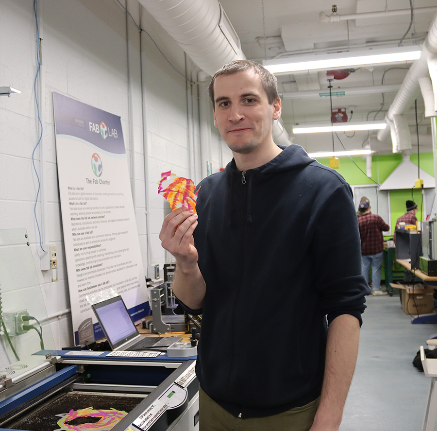 Artem Korotkov, a doctoral student and research from the National University of Science and Technology MISIS in Moscow, uses Fab Lab equipment to make a state of Wisconsin ornament.