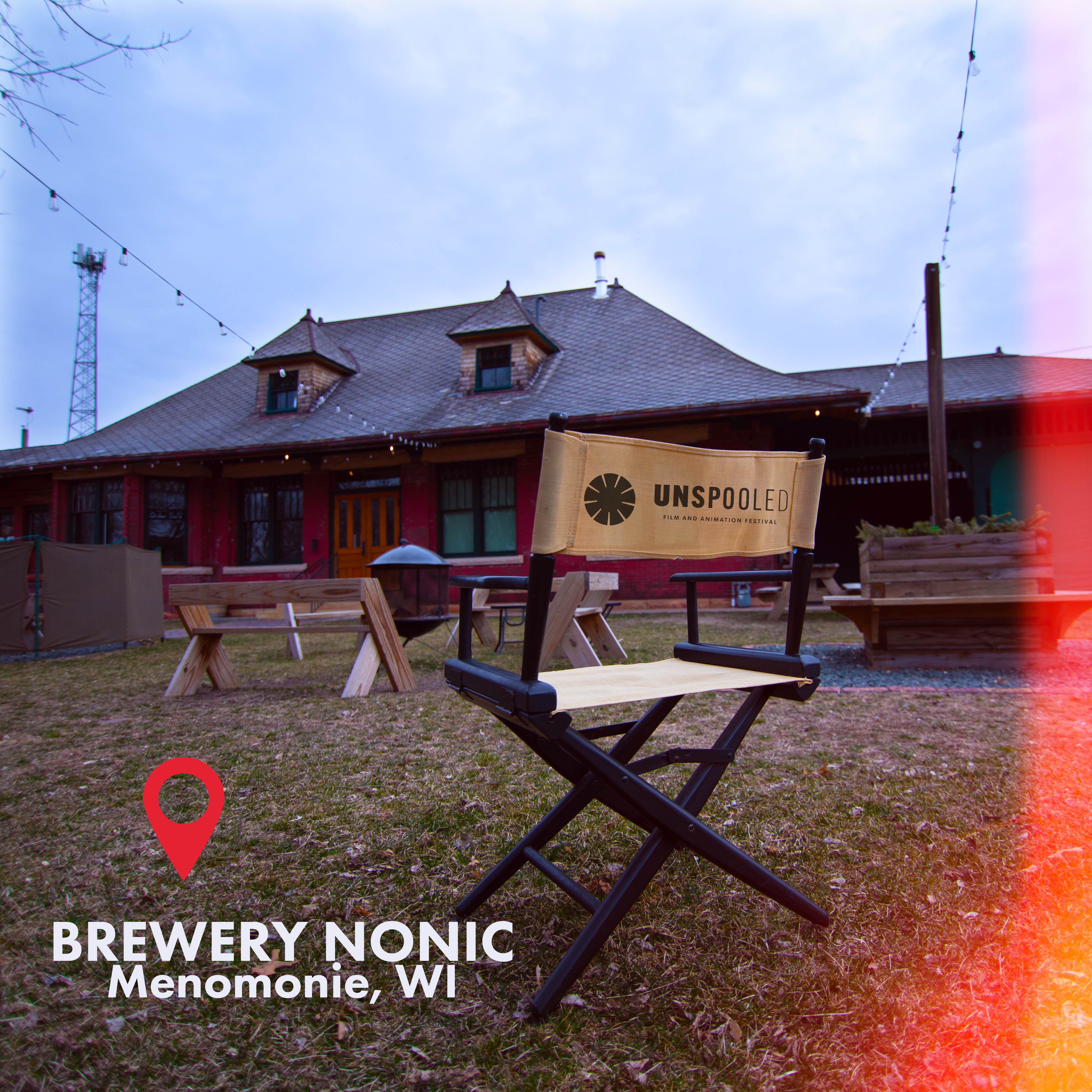 Direct Your Stay at Unspooled Film and Animation Festival - Directors chair sitting on the lawn of Brewery Nonic - facing the building and patio 