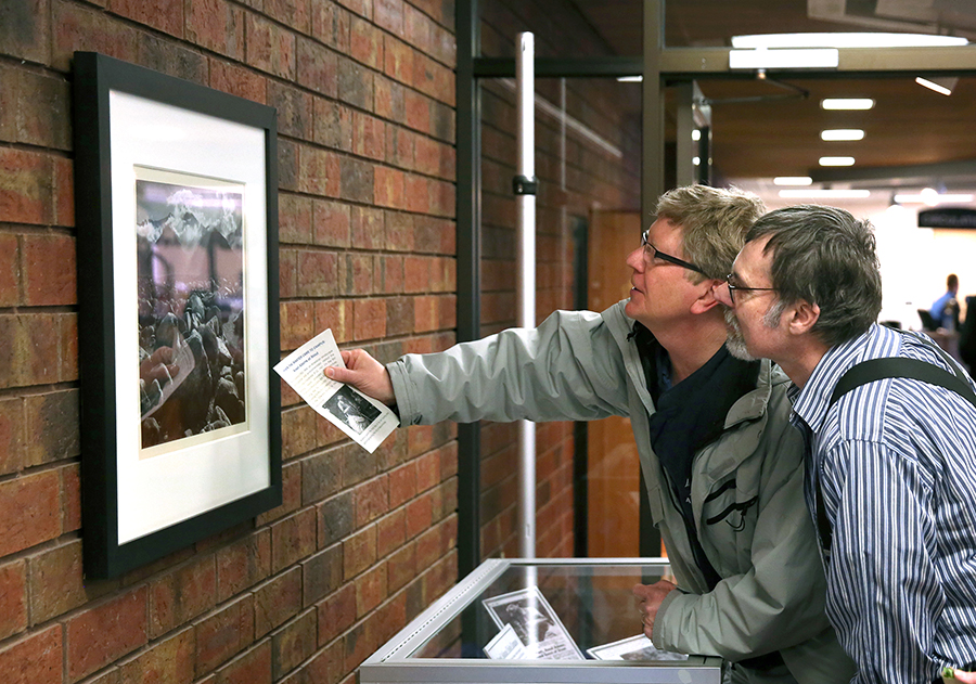 Pitt, at left, looks at an Ansel Adams original photograph donated to the University Library with former UW-Stout photographer Bill Wikrent.