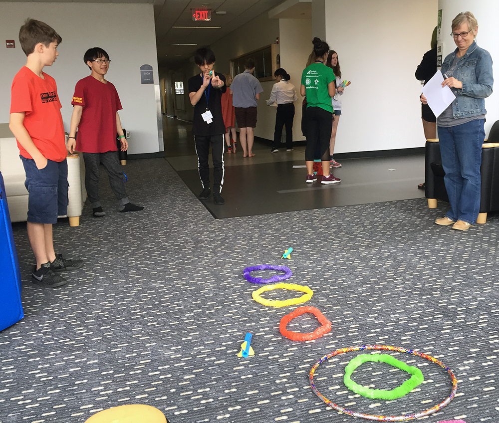 Students at the intercultural leadership portion of the Summer STEAM Experience shoot foam rockets after different groups received varying instructions how to play a game. The students could not speak during the exercise. The goal is to teach students about learning to respond to differences and to understand non verbal language varies across cultures. Intercultural leadership strives to find ways to connect people across cultural differences in ways that acknowledge differences and strengths. 