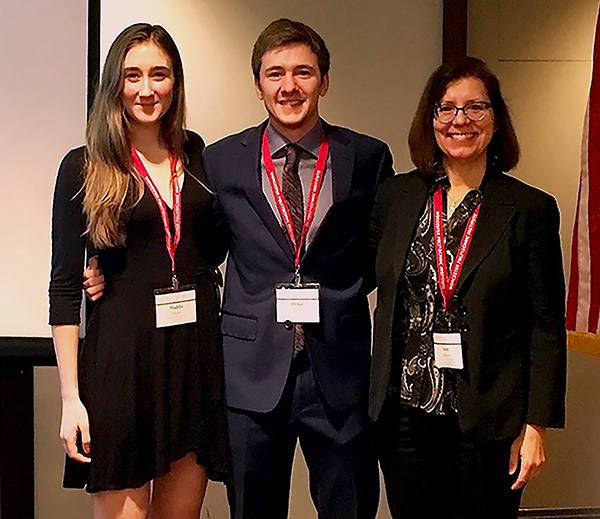 From left, UW-Stout students Maddie Kayser and Dylan Pass with Associate Professor Joan Navarre attend the national honors conference in November in Boston.