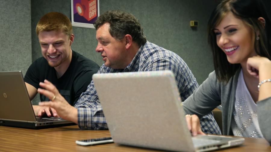 Associate Professor Kevin Tharp and students are photographed during a Web Production and Distribution lab class.