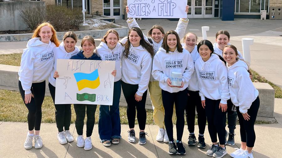 Members of UW-Stout’s gymnastics team promote their #stuckflipforabuck fundraiser for the people of Ukraine. / Kailyn Westbrook photo