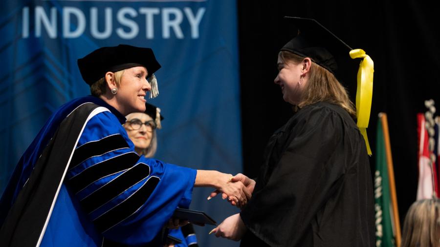 Chancellor Katherine Frank congratulates a graduate during one of the three commencement ceremonies.