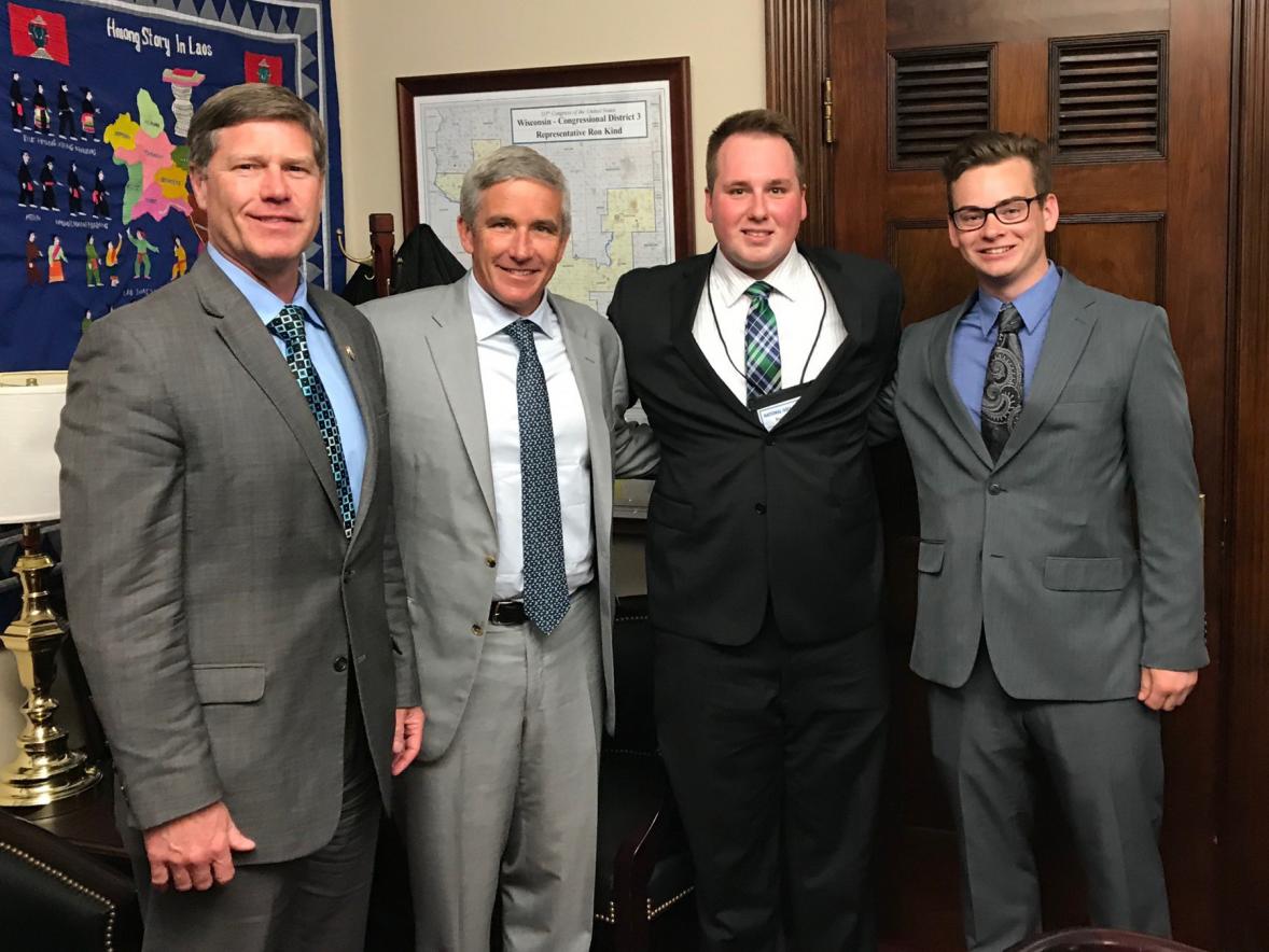 From left, U.S. Rep. Ron Kind of Wisconsin, PGA Tour Commissioner Jay Monahan and UW-Stout students Ryan Hoag and Sawyer Hrycay meet during National Golf Day.
