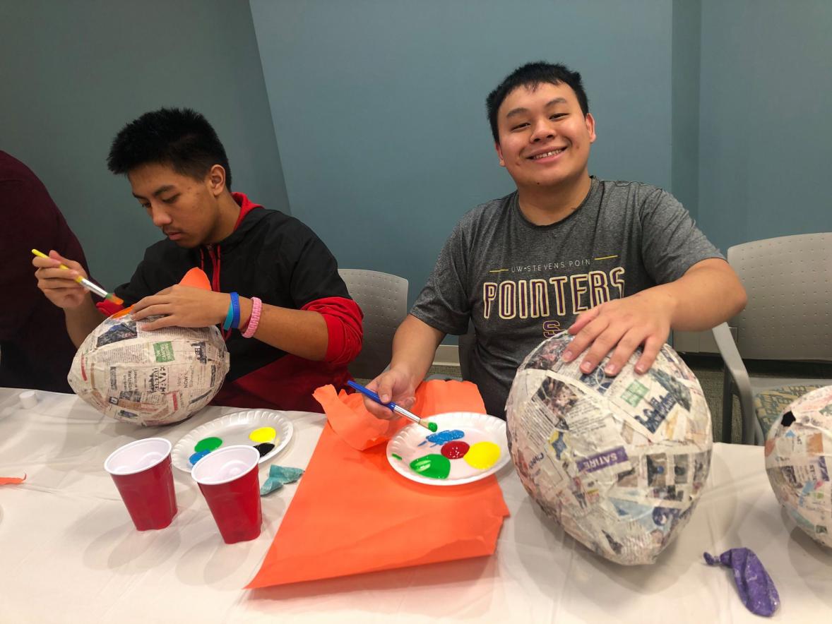 Students with Latinos Unidos create pinatas last year prior to COVID-19.