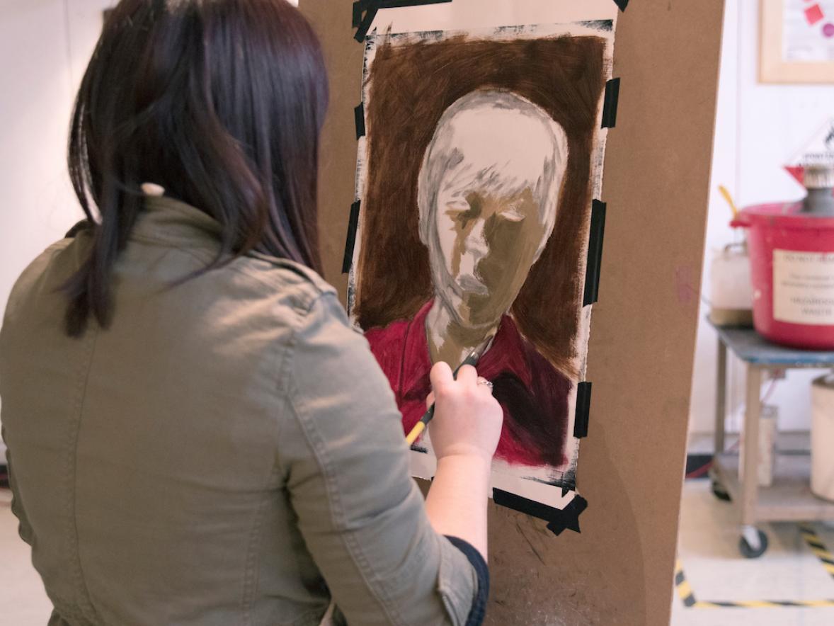 Student creating a portrait in the Drawing Studio. Photo taken pre-COVID.