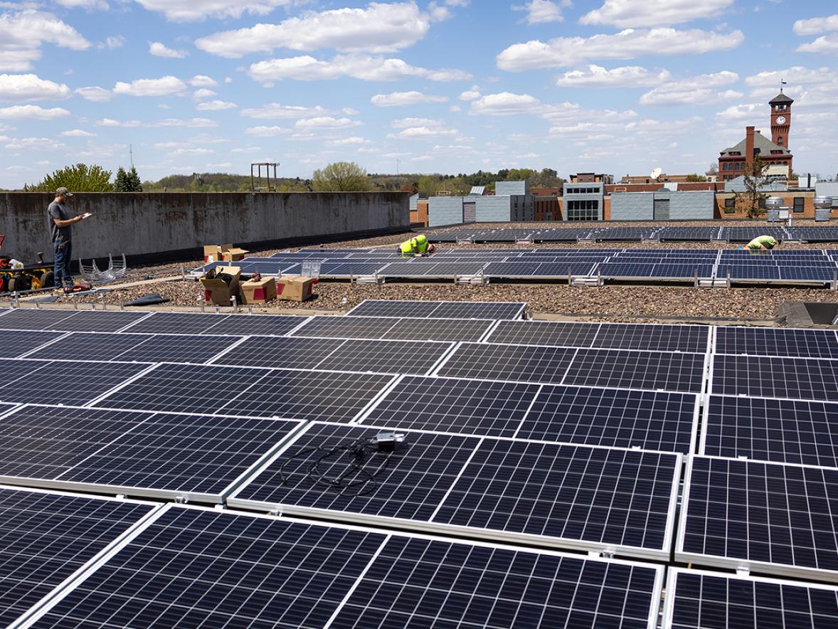 Workers install solar panels recently on UW-Stout’s Merle M. Price Commons building.