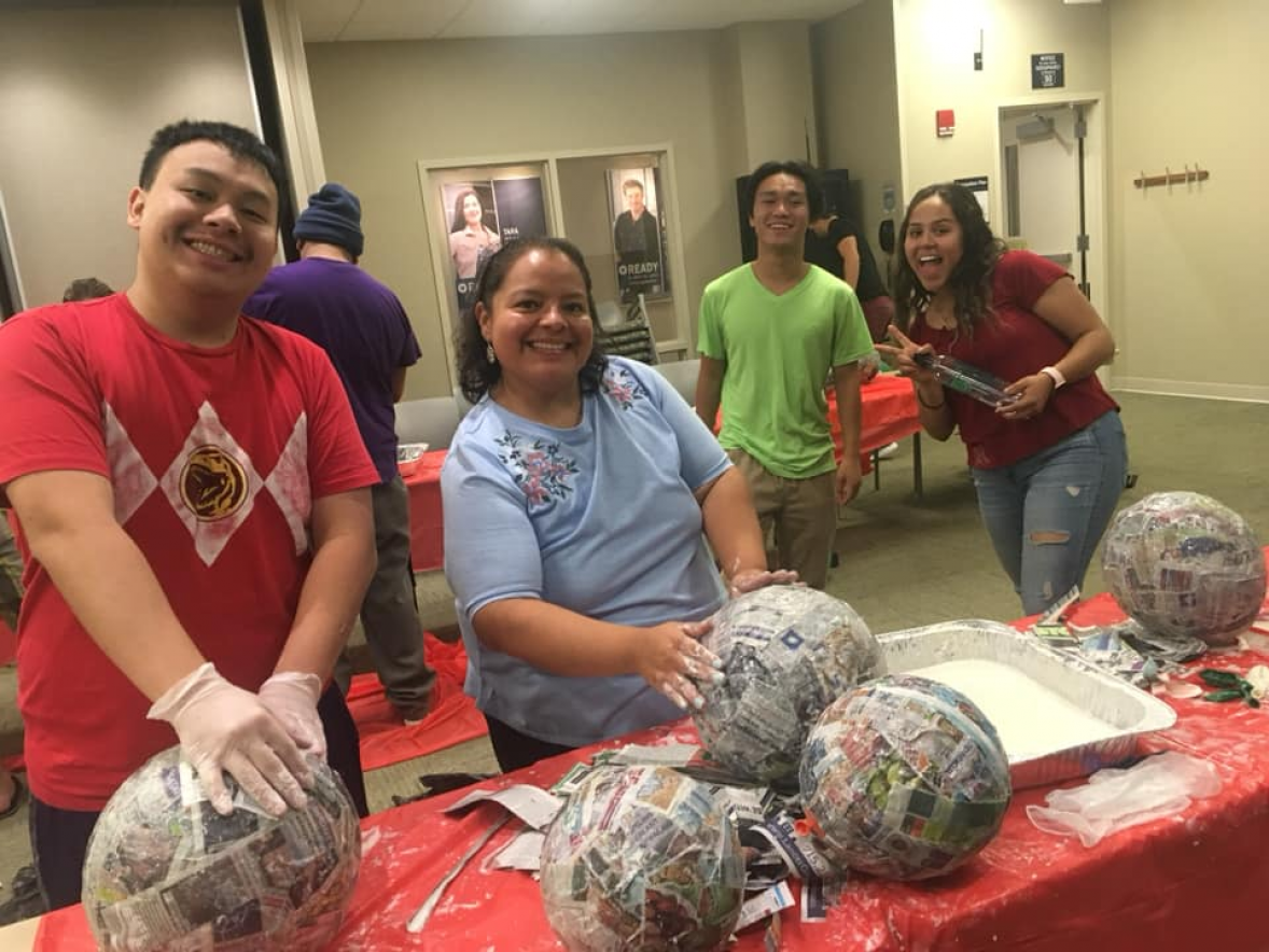 UW-Stout students, with Latinos Unidos adviser Vickie Sanchez, make piñatas prior to COVID-19.