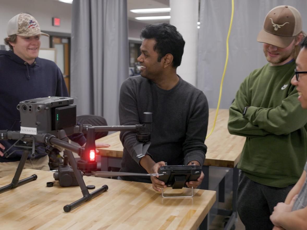 Assistant Professor Abhi Verma helps students assemble drones in an engineering technology class at UW-Stout. 