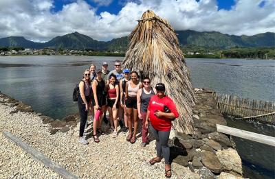 Students studying sustainability at a fishpond in Hawaii.
