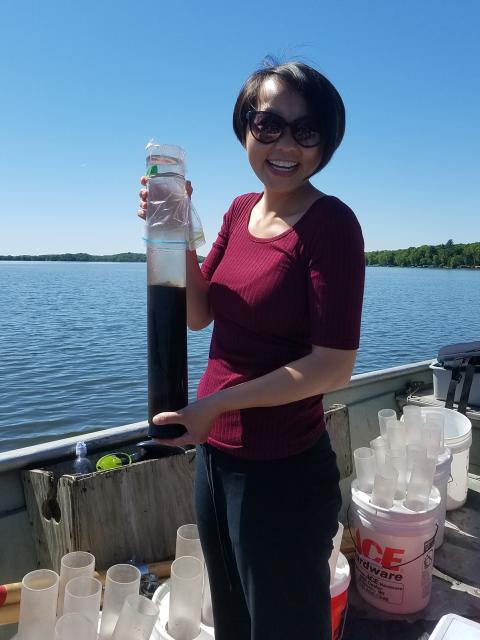 CLRR Manager and UW-Stout alum Mai Lia Vang holds a sediment core from Cedar Lake in Polk County.